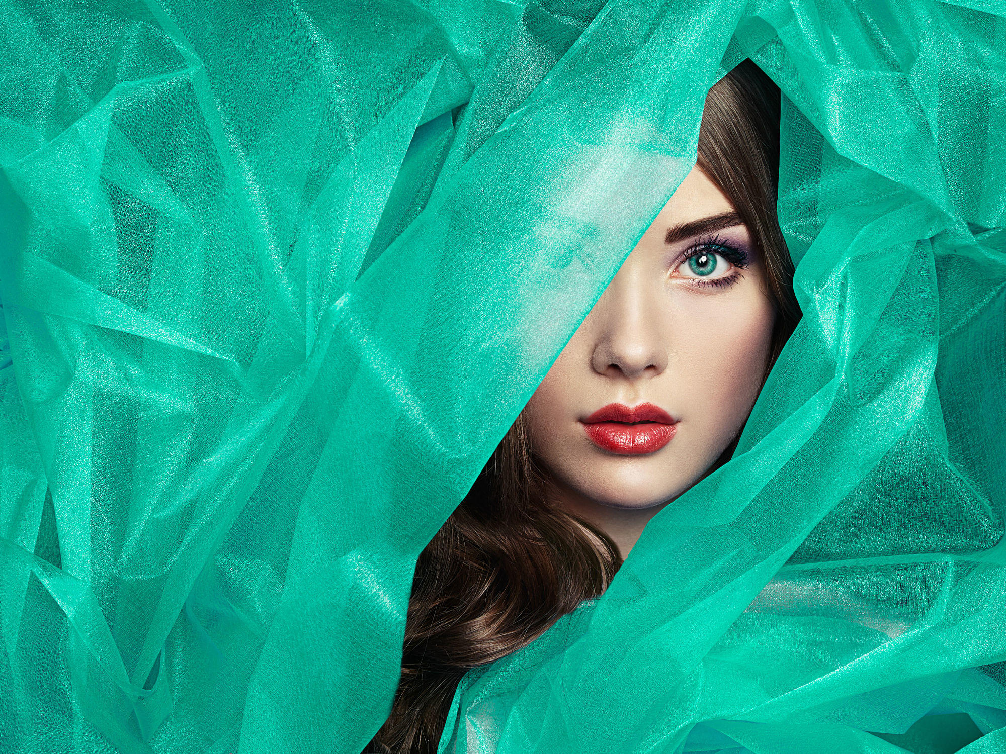 Fashion photo of beautiful women under turquoise veil