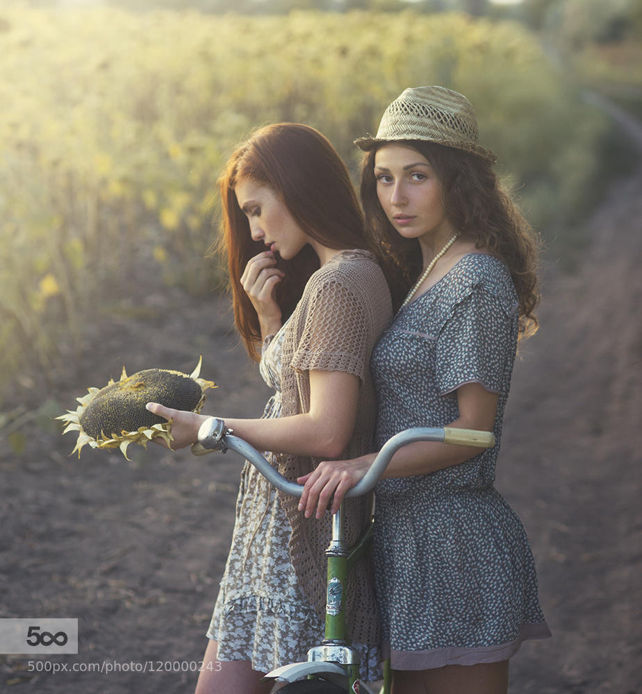 Girls and retro bike on field