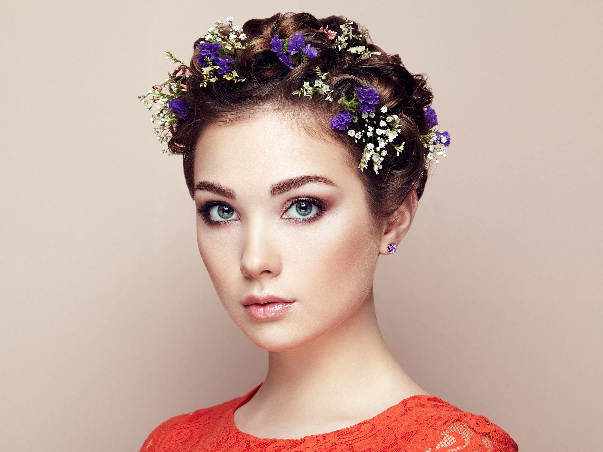 Face of beautiful woman decorated with flowers