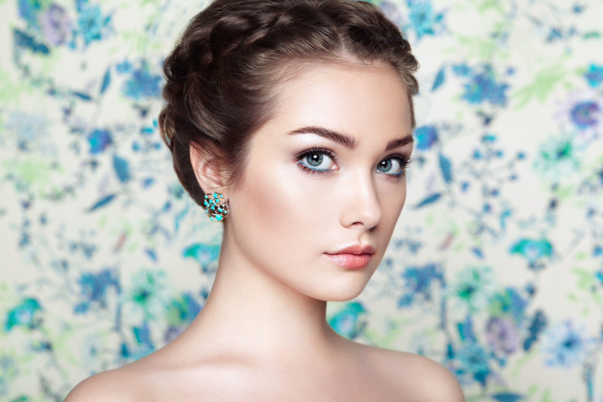 Portrait of young beautiful woman on a background of flowers