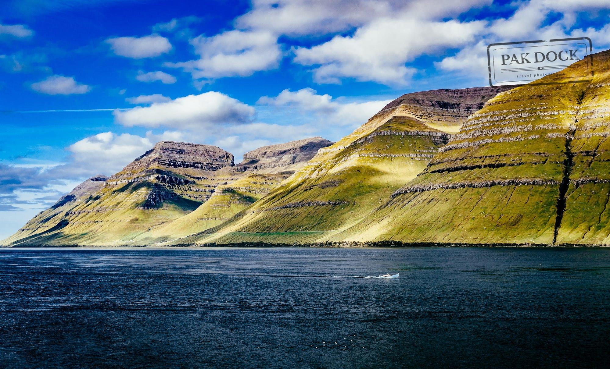 A man fishing in the fjord of Kunoy  - Faroe Islands
